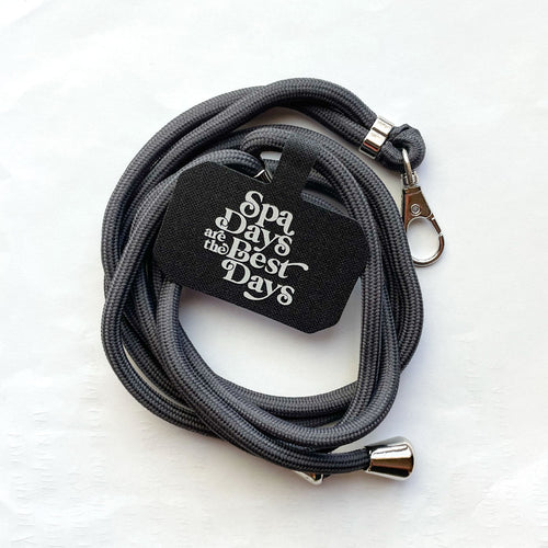 Gray adjustable phone lanyard with metal clasp and a black tag reading "Spa days are the best days" for Crossbody Phone Lanyard With Adjustable Strap | Live Love Spa.