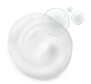 Swirl of creamy white skincare product with clear droplets, representing the texture of Bronze Fox® Tanning Drops | Farmhouse Fresh for body care and wellness.