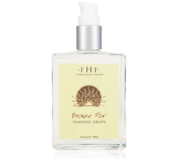Clear glass pump bottle of Bronze Fox® Tanning Drops | Farmhouse Fresh with a light yellow label and sunburst design, skincare product for a natural tan.