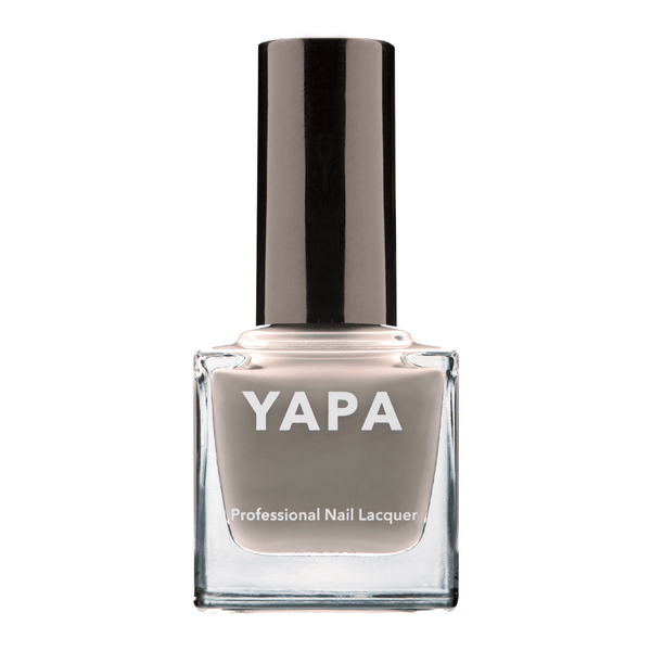 Charlotte Nail Lacquer | YAPA in a sleek glass bottle featuring a muted taupe shade of professional nail lacquer with a black cap for a polished manicure look.