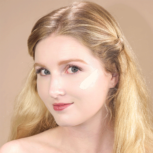 Close-up of a woman with fair skin and blonde hair applying Cool AF Lava Water Foundation | Pretty Vulgar, demonstrating smooth, natural-looking coverage on her cheek.