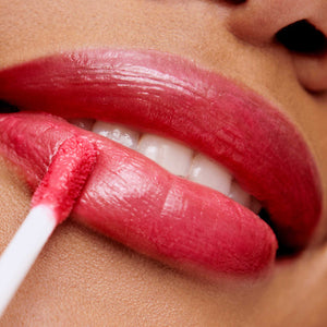 Close-up of lips applying dark berry red Hydropure Hyaluronic Lip Gloss | Jane Iredale for a glossy, moisturizing finish enhancing natural skin tone.
