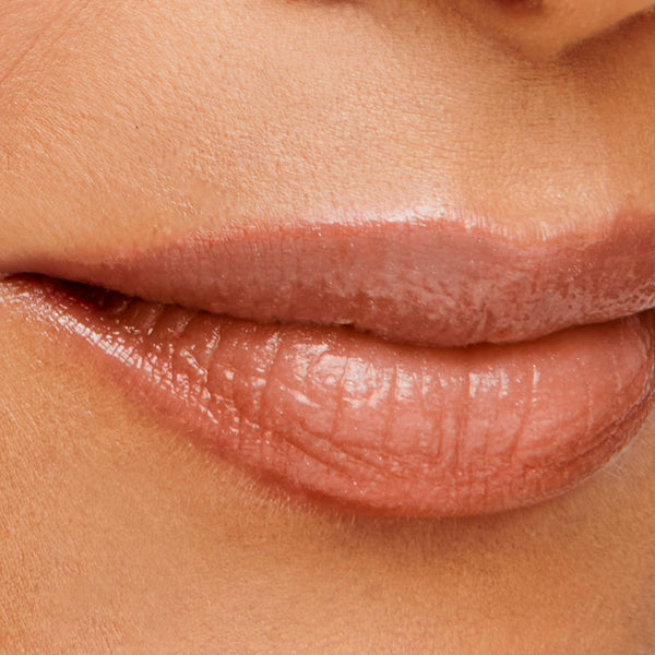 Close-up of lips wearing a natural medium rose shade of Hydropure Hyaluronic Lip Gloss | Jane Iredale, highlighting smooth, hydrated skin and glossy finish.