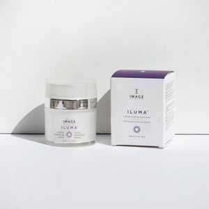 ILUMA intense brightening crème | IMAGE Skincare in a white jar with silver accents next to its white and purple retail box, displayed on a clean white surface for skincare and wellness supplements.