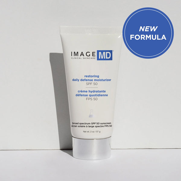 Tube of Restoring Daily Defense Moisturizer SPF 50 | IMAGE Skincare with broad spectrum sunscreen, displayed against a neutral background with a "New Formula" badge.