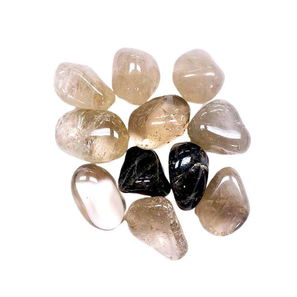 Clear and smoky polished stones arranged on a white background representing natural wellness and recovery tools paired with Defense Essential Oil Vial | Aluminate Life.