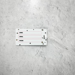 Luggage Tag - Meditating Fox- Limited Edition | Lucky Owl showing the white label side with fields for name, email, and phone on a textured grey background.