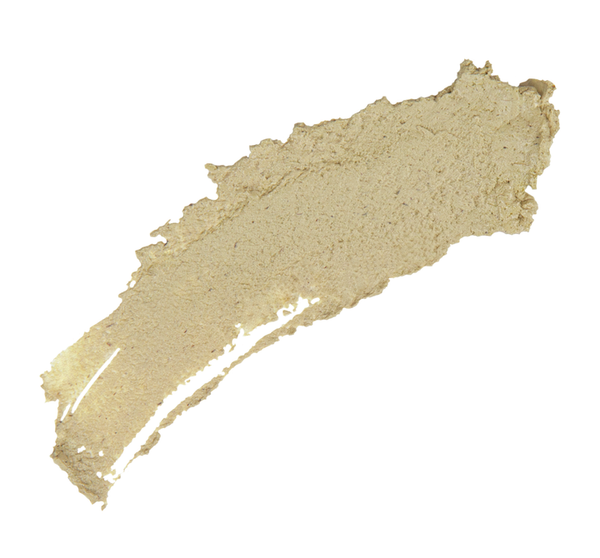 Close-up of a textured beige green tea skincare mask smear, representing Matcha Purity™ Calm & Clear Purification Mask | FarmHouse Fresh for soothing and clarifying skincare.