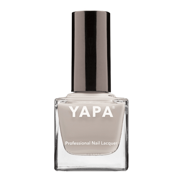 Michelle Nail Lacquer | YAPA in a sleek glass bottle with a neutral beige shade and a shiny black cap, designed for professional nail care and polish application.