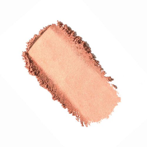 Smudged swatch of soft peachy pink powdered makeup showcasing texture and pigmentation of Purepressed Blush | Jane Iredale.