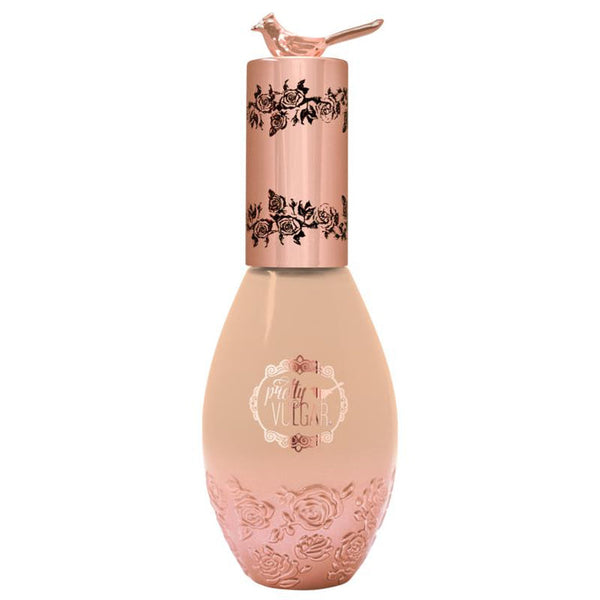 Elegant foundation bottle with rose gold floral design and bird detail on cap, labeled Cool AF Lava Water Foundation | Pretty Vulgar, showcasing a luxurious skincare product.