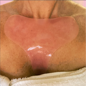 Close-up of a clear hydrating reusable chest pad applied on the chest area, designed to soothe and moisturize skin, showcasing the Hydrating Reusable Chest Pad | Dreambox Beauty.