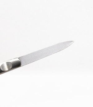 Close-up of a fine textured steel tool used for skincare grooming, designed for precise use in wellness routines, featured as part of Clip Clip | Barefoot Scientist.