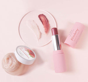 Strawberry Wine 2-Step Luscious Lip Kit | FarmHouse Fresh with lip scrub and tinted lip balm displayed on a soft pink background for skincare and lip care indulgence.