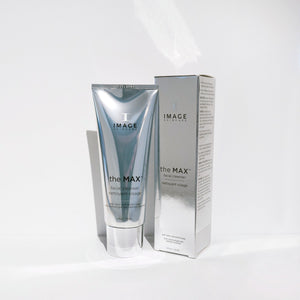 Silver tube and matching box packaging of the MAX™ facial cleanser | IMAGE Skincare displayed on a white surface, highlighting modern skincare product design.
