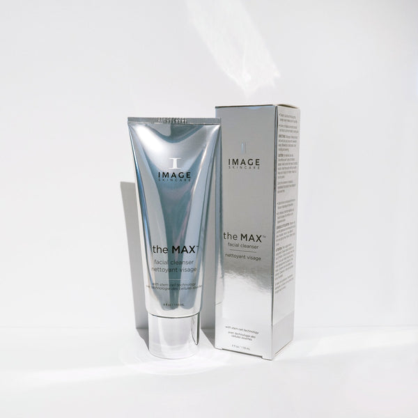 Silver tube and matching box packaging of the MAX™ facial cleanser | IMAGE Skincare displayed on a white surface, highlighting modern skincare product design.
