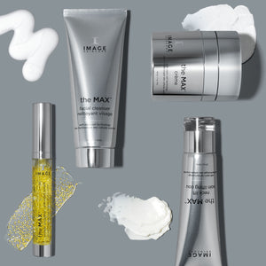 Silver and clear skincare containers from the MAX™ crème | IMAGE Skincare set displayed with product swatches on a gray surface for skincare and wellness supplements.