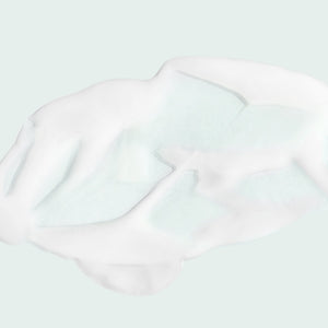 Close-up of white creamy texture of the MAX™ serum | IMAGE Skincare on a light background, highlighting its smooth and rich consistency for skincare use.