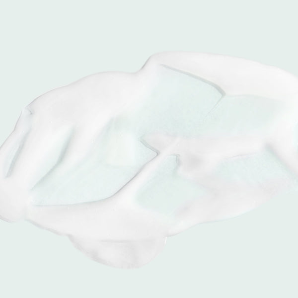 Close-up of white creamy texture of the MAX™ serum | IMAGE Skincare on a light background, highlighting its smooth and rich consistency for skincare use.