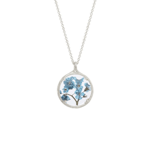 Small silver necklace featuring delicate blue flowers encased in a round pendant, showcasing the unique design of Small Botanical Necklace | Catherine Weitzman Jewelry.