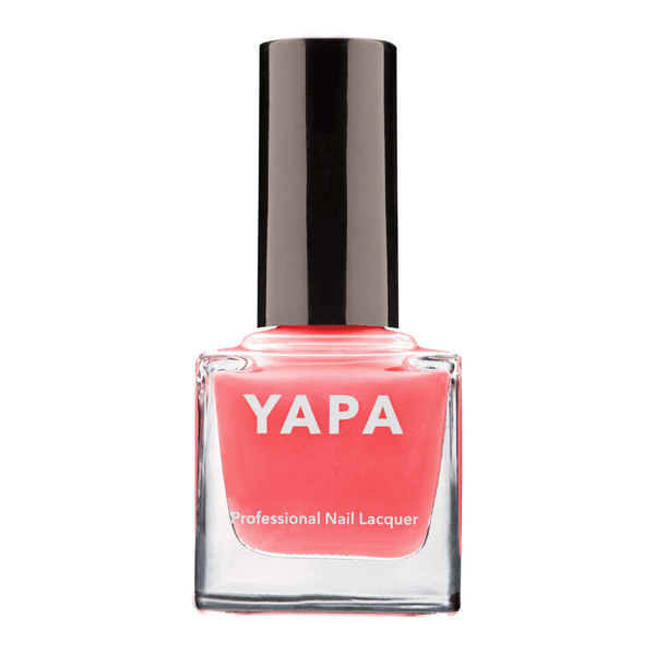 A coral pink nail polish bottle with a black cap labeled Claire Nail Lacquer | YAPA, showcasing a professional lacquer for vibrant nail color.