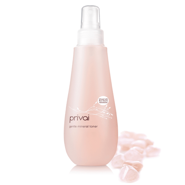 Gentle Mineral Toner - Infused w/ Rose Quartz | Privai in a sleek pink bottle with rose quartz stones, promoting soothing skincare and wellness benefits.