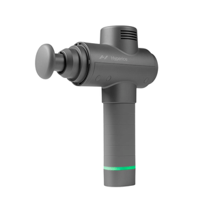 Hypervolt 2 | Hyperice percussive massage device in gray with ergonomic handle and round attachment, designed for muscle recovery and wellness care.