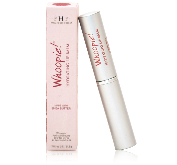 Whoopie® Hydrating Lip Balm | Farmhouse Fresh in sleek silver packaging alongside a pink box, featuring moisturizing shea butter for smooth, hydrated lips.