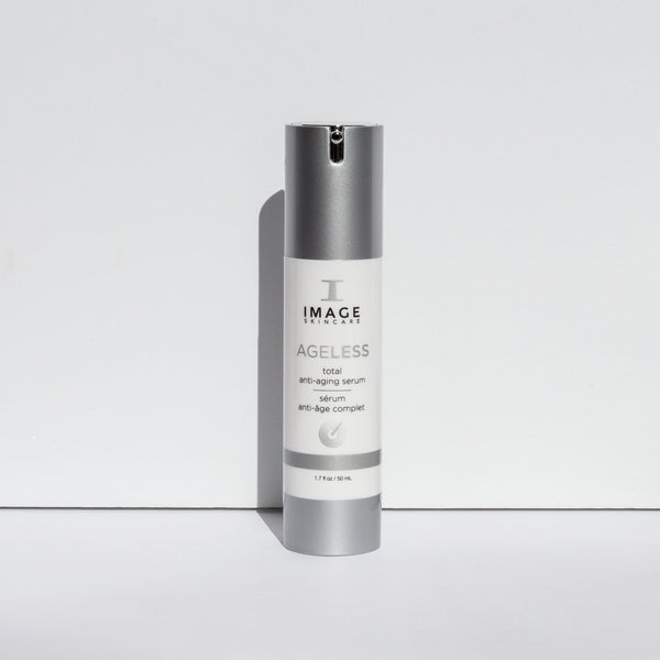 Bottle of AGELESS total anti-aging serum | IMAGE Skincare standing upright with a silver cap and white label on a plain white background, showcasing skincare product design.
