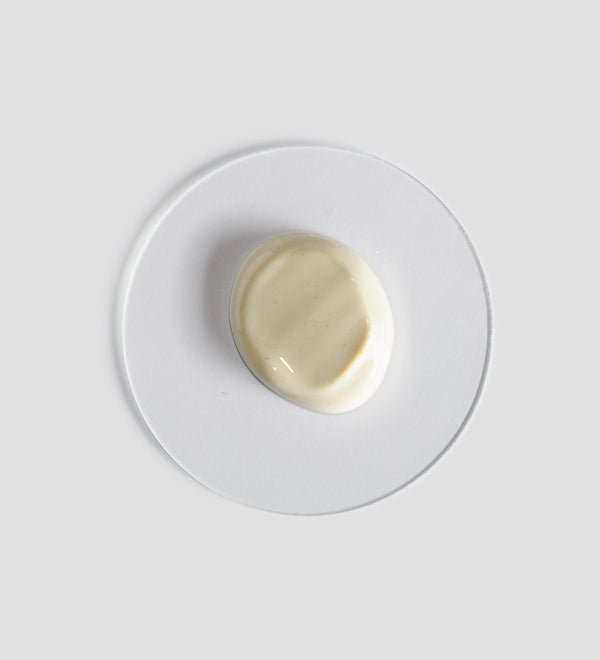 Creamy beige skincare product sample on a clear glass dish representing the texture of Active Pureness Mask | [ comfort zone ] for skincare and wellness.
