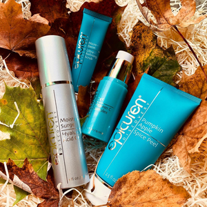 Moisture Surge Hyaluronic Acid Gel | Epicuren Discovery bottle alongside blue skincare tubes surrounded by autumn leaves, highlighting skincare and wellness products.