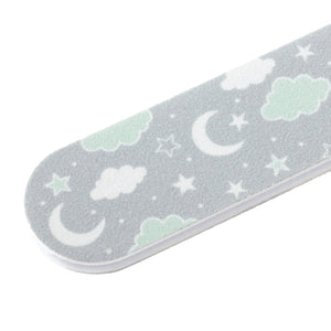 Close-up of a baby nail file with a soft gray surface decorated with white and mint green clouds, stars, and crescent moons, part of the Baby Manicure Kit | Tweezerman.