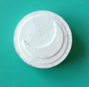 Close-up of a single white Luna Wipes - Eco Pak (35 Wipes) | Functional Botanicals wipe with a moon-shaped embossed design on a teal background, representing skincare and body care.