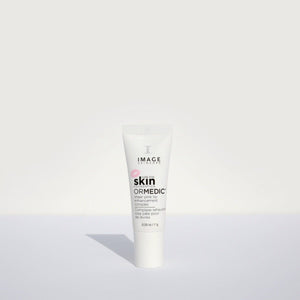 Tube of ORMEDIC sheer pink lip enhancement complex | IMAGE Skincare standing upright on a plain white surface with soft shadow and minimalistic background.