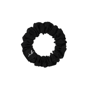 Black fabric hair scrunchie with subtle branding, designed for gentle, comfortable hold, part of the LOOP 3 pc | invisibobble collection.
