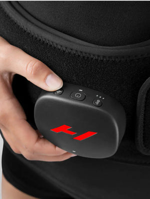 Close-up of a hand adjusting the control unit on the Venom 2 Back | Hyperice recovery device, designed for targeted muscle relief and wellness.